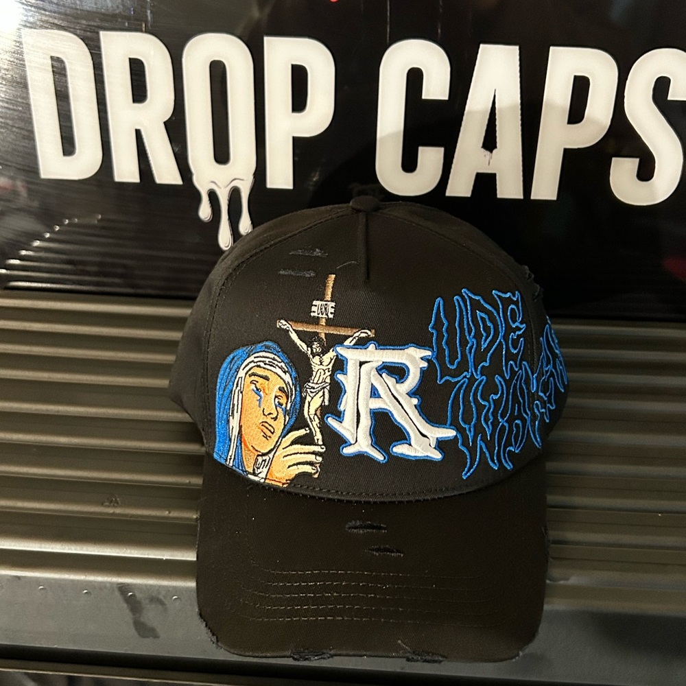 RUDE AWAKENINGS CRUCIFIXION HAT EMBROIDERY Black Cap with Blue Graphic Design